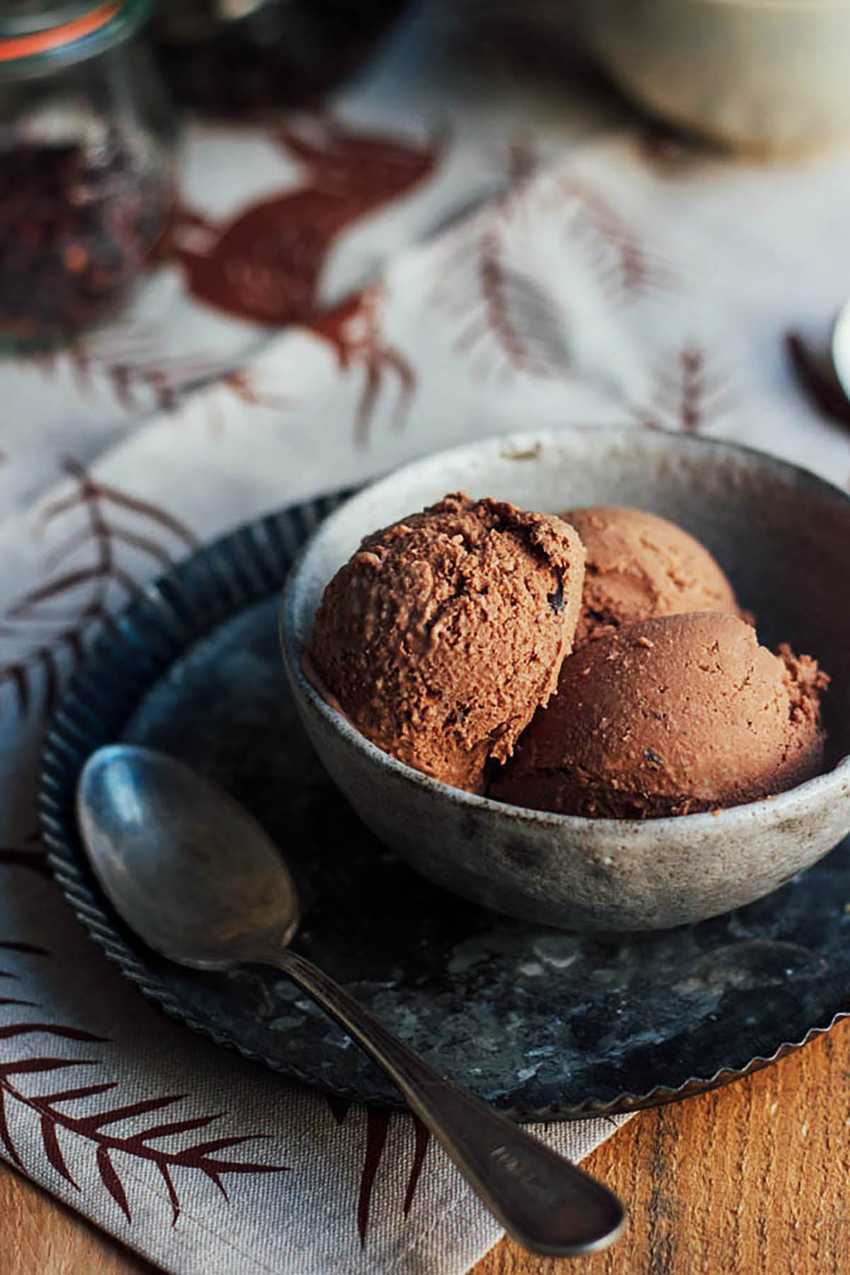 Three scoops of chocolate ice cream in a small bowl.