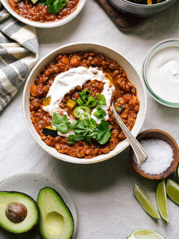 Lentil chili topped with sour cream and herbs.