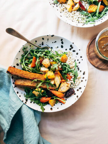 Two grain bowls with tempeh and vegetables.