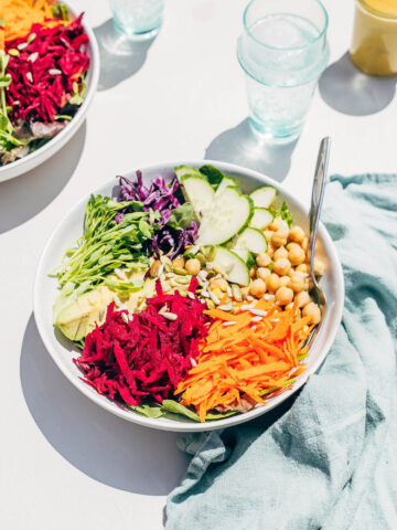 A bowl of shredded vegetable salad in sunlight.