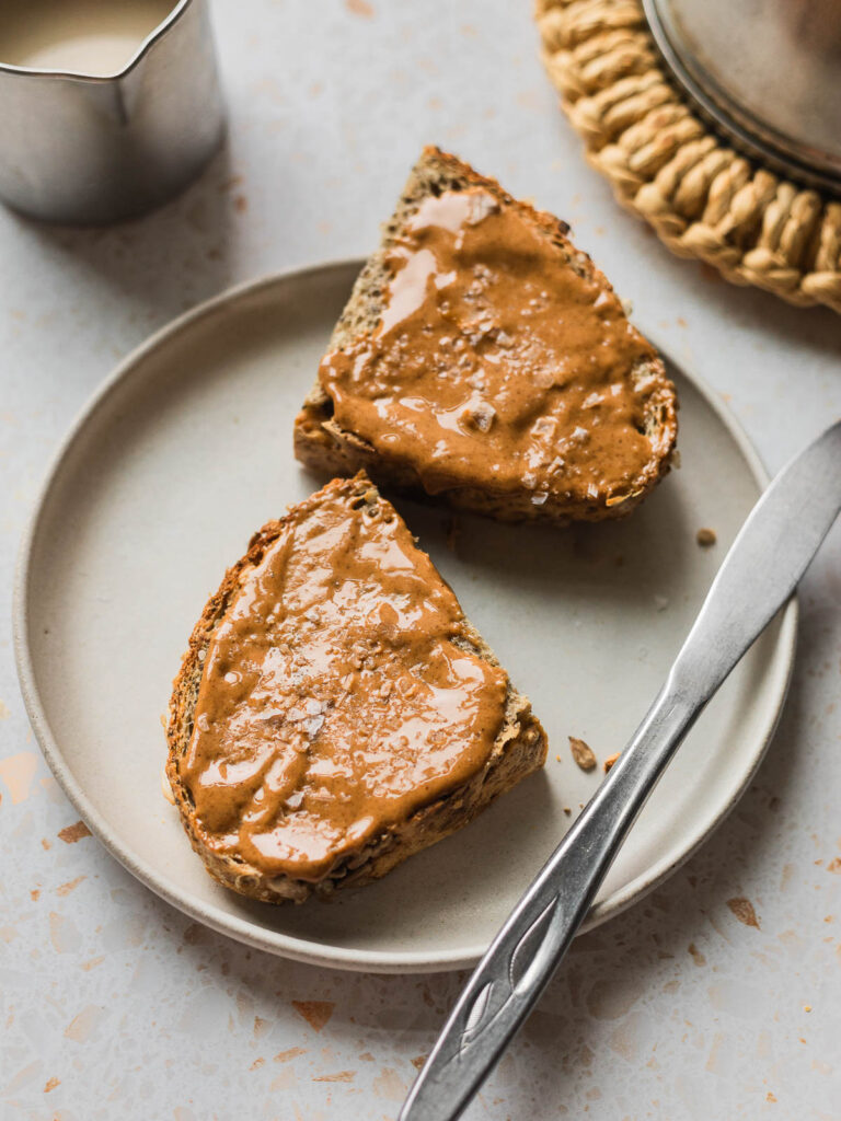 Image of protein bread on a plate covered with nut butter