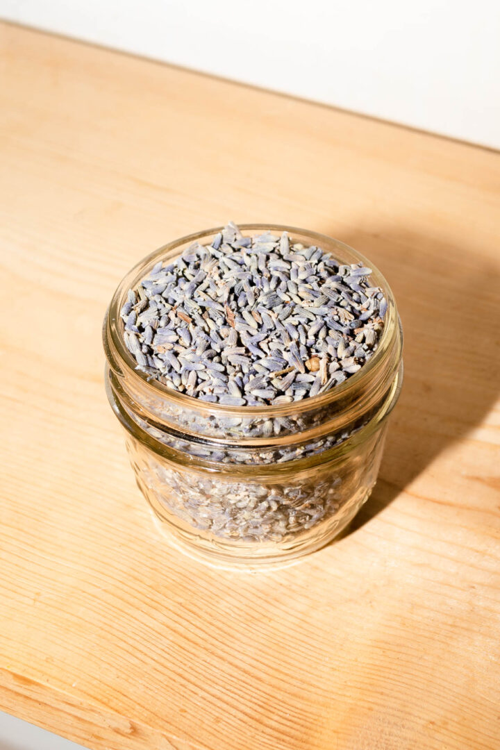 A jar of lavender flowers on a kitchen shelf