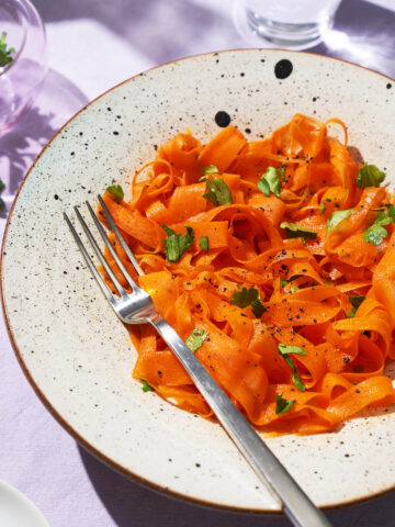 Ribboned carrot salad in a serving bowl.