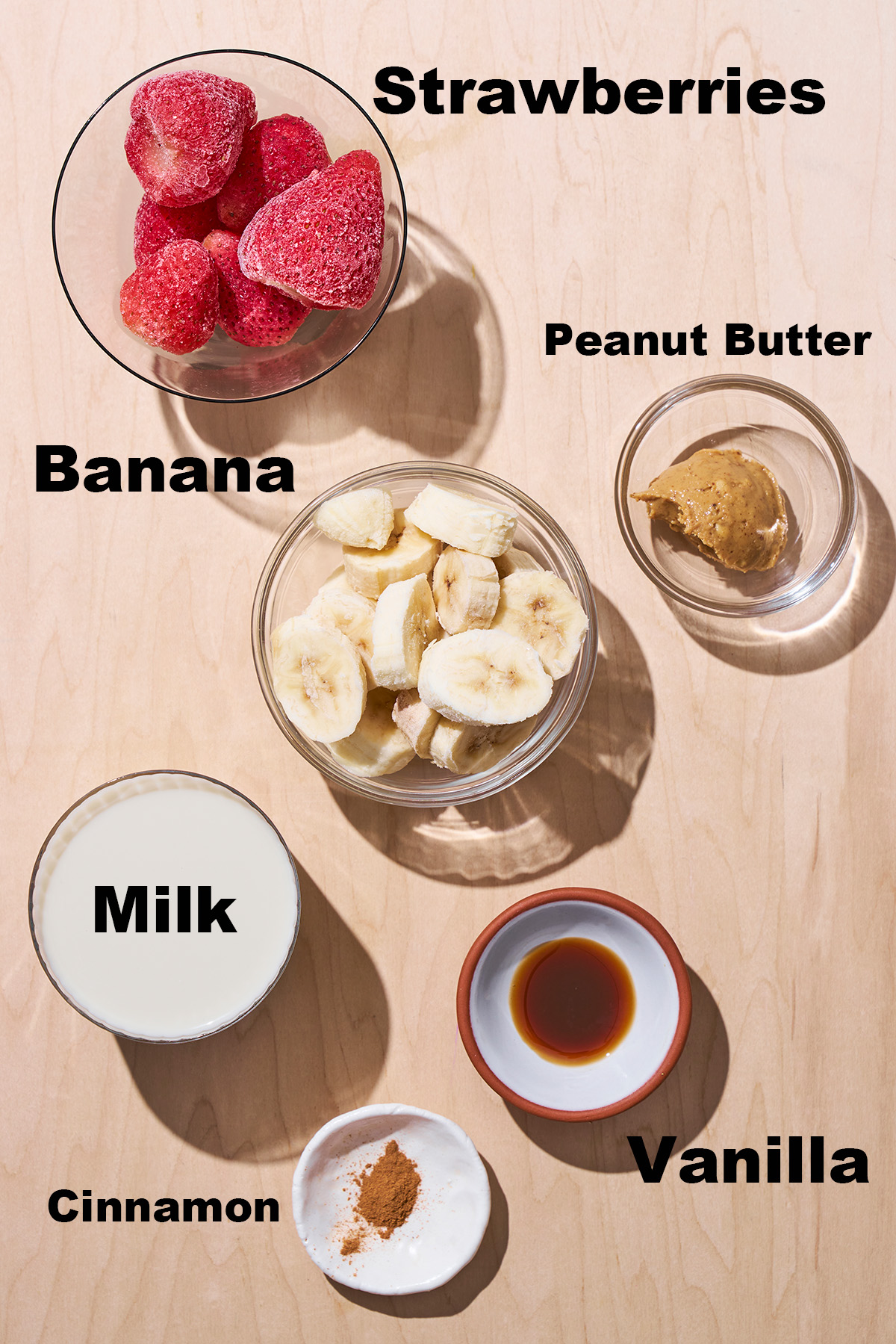 Strawberry banana peanut butter smoothie ingredients with labels.