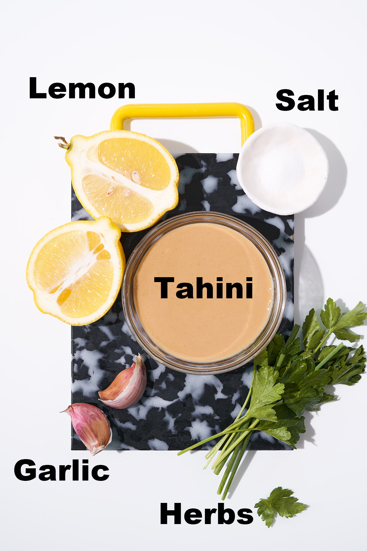Lemon herb tahini sauce ingredients with labels.