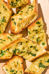 Close up of several pieces of garlic bread.