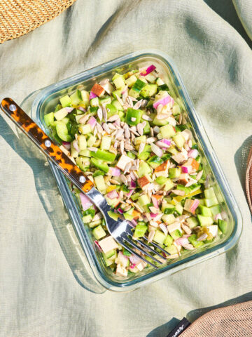 A rectangular glass container filled with vegetable chopped salad.