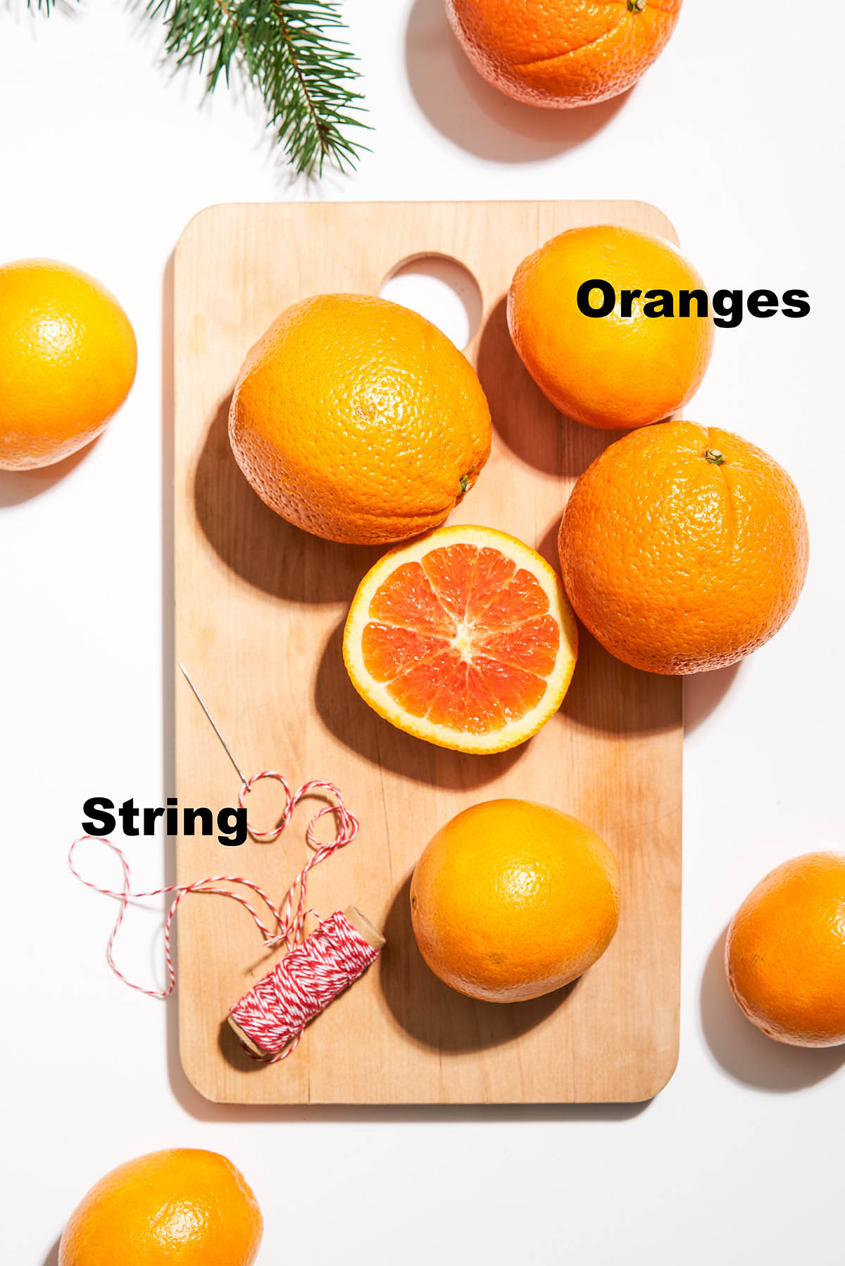 Items needed for a dried orange garland with labels.