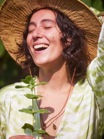 Smiling woman in a large hat.